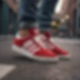 Red and white Adidas sneakers in urban skateboarding setting