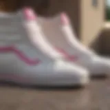 Close-up view of white high top Vans with pink stripe showcasing the texture and design details