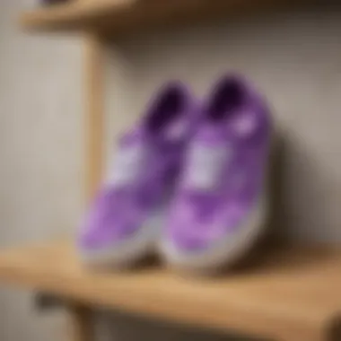 A collection of purple tie dye Vans displayed creatively on a shelf