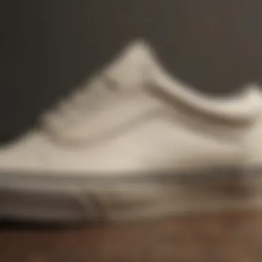 Close-up view of cream Old Skool Vans showcasing the iconic side stripe and texture.