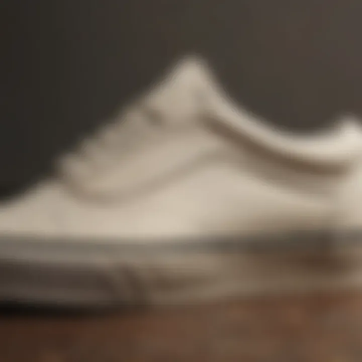 Close-up view of cream Old Skool Vans showcasing the iconic side stripe and texture.