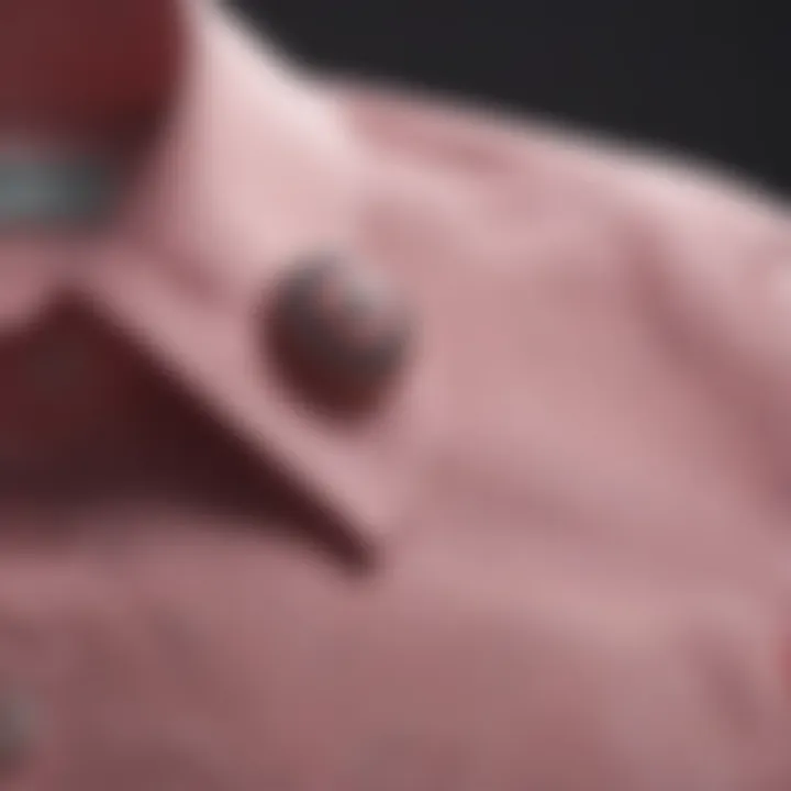 Close-up of intricate details on a pink button-down shirt fabric