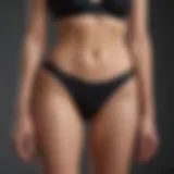 Elegant black high cut bikini bottom showcased against a minimalist background.