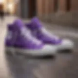 Purple Converse high tops on a skateboard