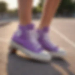 A pair of lavender purple Converse shoes on a skateboard at a park