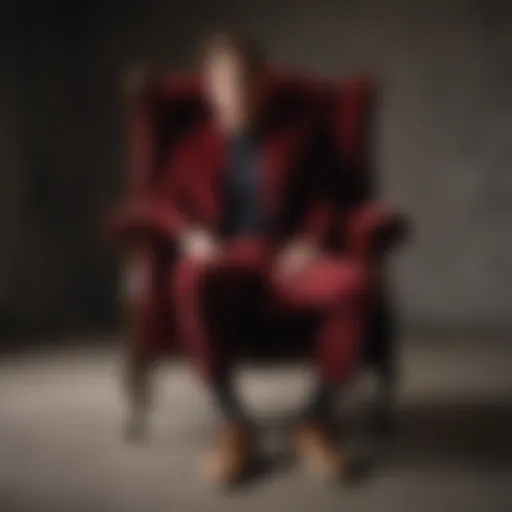 Elegant maroon pants draped over a luxurious velvet chair