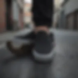 Sleek all black slip-on platform Vans against an urban backdrop.