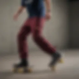 A skater performing a trick in maroon Dickies pants