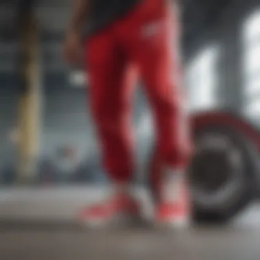 Detailed shot of vibrant sweatpants with skateboard wheels Close-up of red and white sweatpants with skateboard wheels