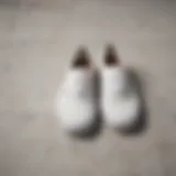 Iconic Vans Authentic All-White Shoes on Marble Surface