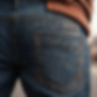 Close-up of intricate stitching details on man brand jeans worn by a skateboarder