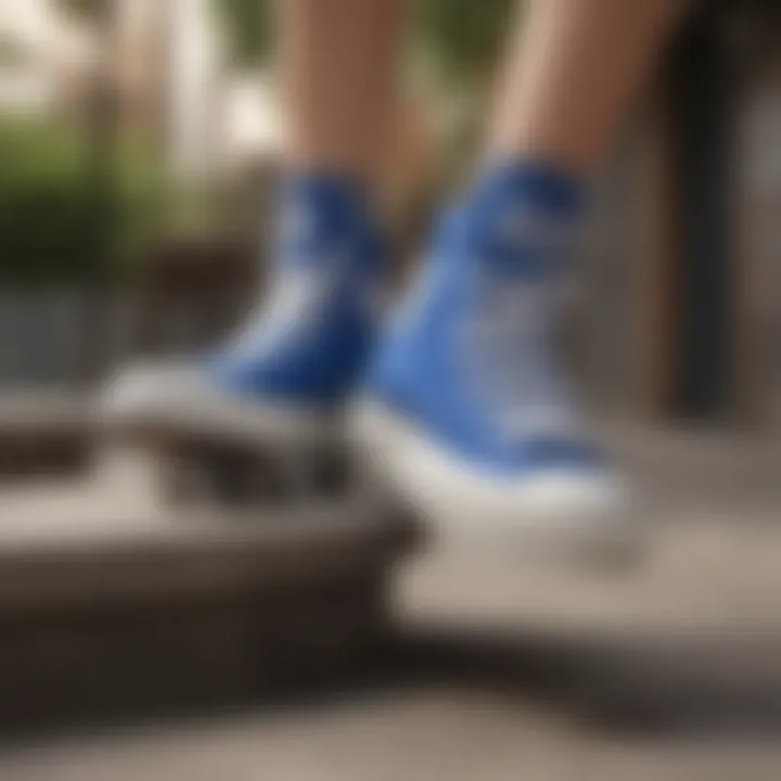 Skateboarder performing tricks while wearing blue Converse