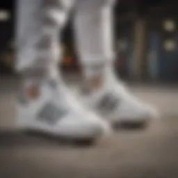 A close-up of white on white Adidas sneakers on a skateboard.