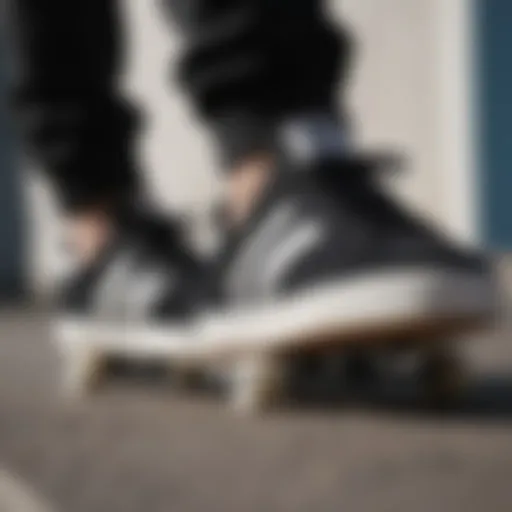 Close-up of Adidas black shoes with white stripes on a skateboard