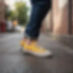 Yellow Converse low tops on a skateboard