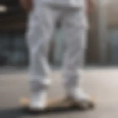 Close-up of all white Adidas pants on a skateboard