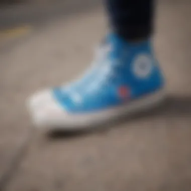 Close-up of blue Converse shoes adorned with skateboard stickers