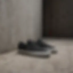 Minimalistic black sole slip-on Vans against concrete backdrop